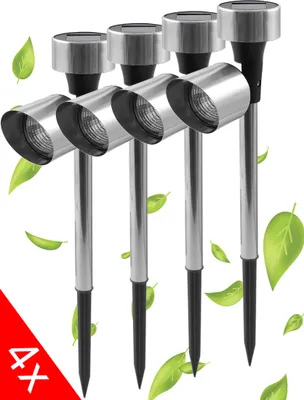 A set of four solar-powered garden lights with stakes, surrounded by green leaves.