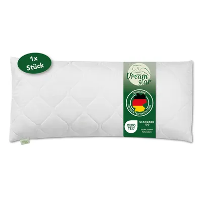 A white quilted pillow is presented flat against a white background, with product information labels attached to it.