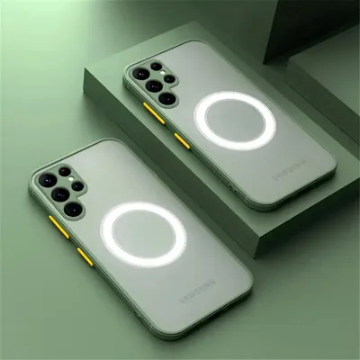 Two light green phone cases with a magnetic ring are displayed on a green platform against a green background.
