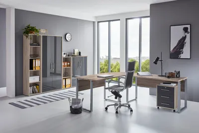 A modern office setting with a desk, chair, and storage units.