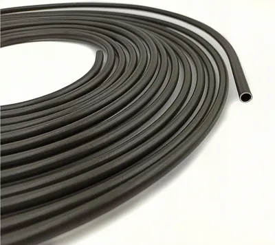 A coiled roll of dark gray tubing on a white background.
