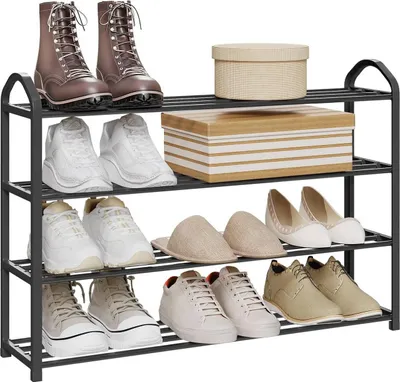 A metal shoe rack filled with various types of footwear and two decorative boxes.