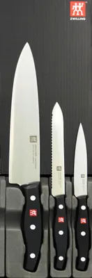 A set of three kitchen knives displayed in a black presentation box.