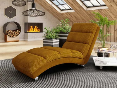 A modern living room with a chaise lounge, fireplace, and plants.