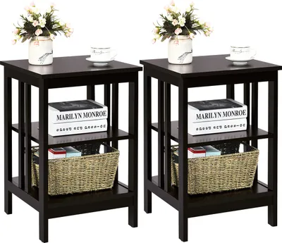Two identical dark brown end tables are shown side-by-side against a white background. Each table has two shelves and is decorated with a vase of flowers and a cup on the top surface, and a woven basket and books on the shelves.