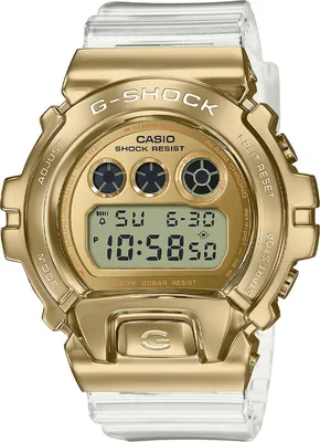 A close-up, front-facing studio shot of a gold Casio G-Shock watch with a clear band against a white background.