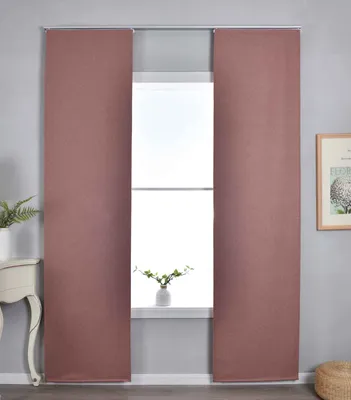 Two panel curtains are shown hanging in front of a window, with a small plant on the windowsill.