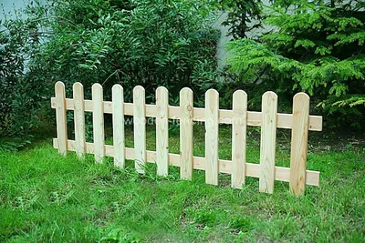 A wooden fence in a garden setting.
