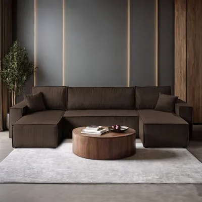 A modern living room with a large sectional sofa, coffee table, and plant.