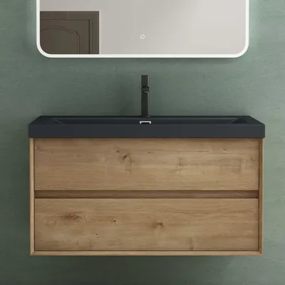 A bathroom vanity with a sink and faucet against a green wall.