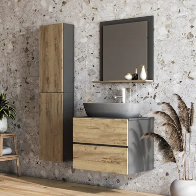 A modern bathroom vanity with a sink and mirror, set against a textured tile wall.