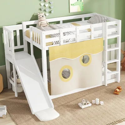 A white bunk bed with a slide and a yellow curtain with circular windows, set in a child's room.