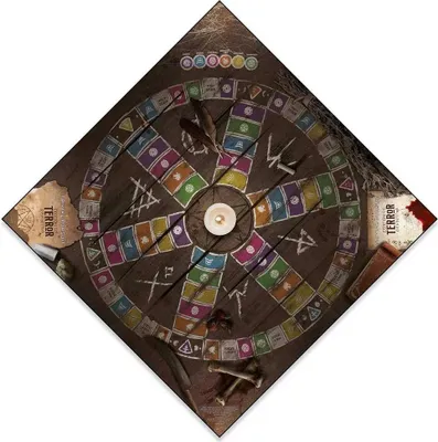 A board game laid out on a wooden surface, with a candle in the center.
