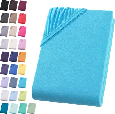 A folded turquoise fitted sheet is shown on the right side of the image, with a grid of smaller swatches of various colored fitted sheets on the left.