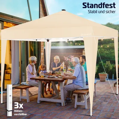A family is having a meal under a beige pop-up canopy tent on a patio.