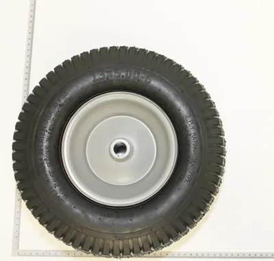 A single wheel with a tire and rim, placed on a white background with rulers on the sides.