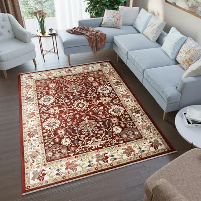 A living room scene with a sectional sofa, armchair, and a rug.