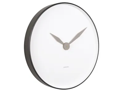 A close-up, angled view of a modern wall clock with a white face and black frame.