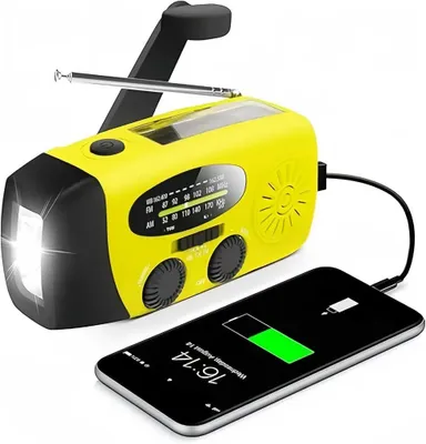 A yellow emergency radio is shown connected to a smartphone, charging it.