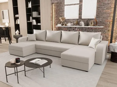A U-shaped sofa is shown in a modern living room setting with a brick wall and shelves in the background.
