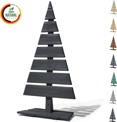 A dark gray wooden Christmas tree decoration stands in the center of a white background, with smaller versions of the tree in various colors displayed to the right. A circular logo with German flag colors and the text '100% NATURAL' is in the top left corn