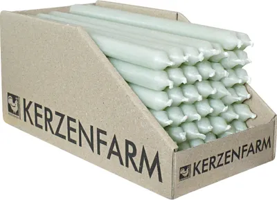 A cardboard display box filled with light green candles.