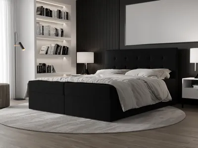 A modern bedroom scene featuring a black boxspring bed with a tufted headboard, bedside tables, and a bookshelf.
