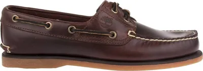A side view of a brown leather boat shoe.