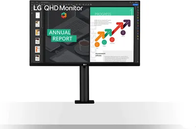 A black LG QHD monitor on a stand, displaying an annual report presentation.