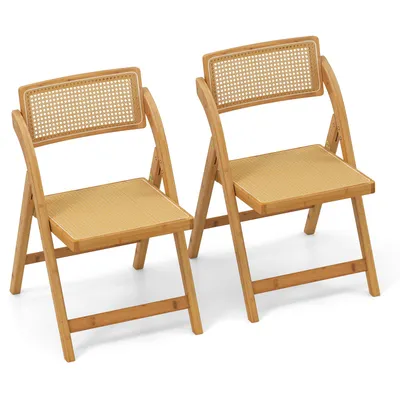 Two folding chairs made of bamboo with rattan backrests.