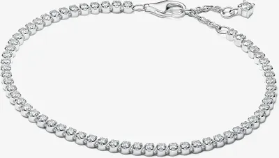 A close-up studio shot of a silver tennis bracelet with clear cubic zirconia stones.