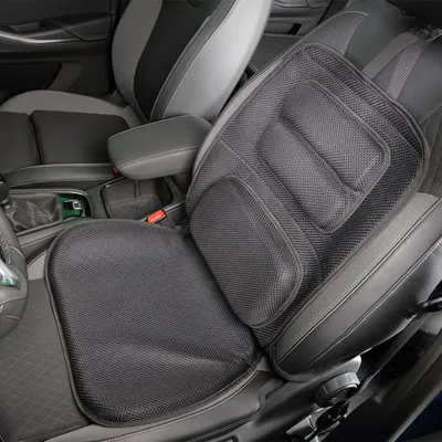 A black mesh seat cushion is placed on a car seat.