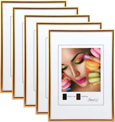 A stack of gold-colored picture frames with one frame displaying a close-up of a woman's face with colorful makeup and macarons.