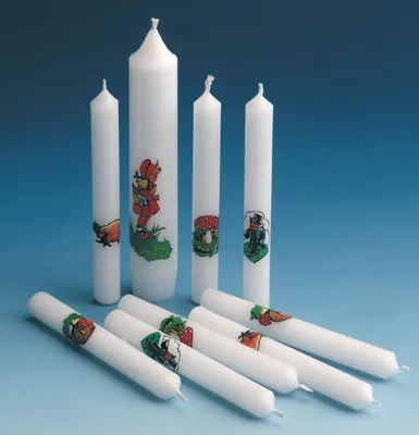 A collection of white candles with cartoon illustrations, arranged on a blue background.