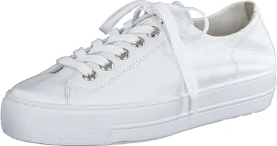 A white leather sneaker with laces and a thick white sole, shown from a side angle against a white background.