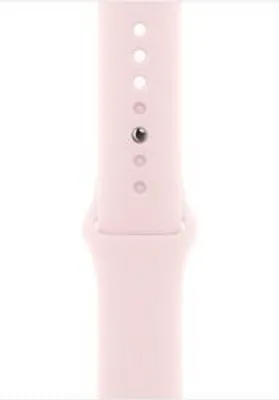 A close-up of a pink watch band with holes for adjustment.