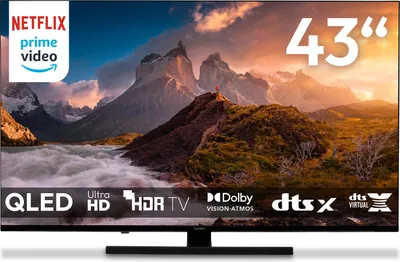 A television screen displaying a mountain landscape, with various logos and text overlays indicating product features.
