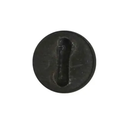 A close-up of a black circular object with a slot in the center.