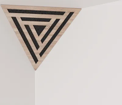 A triangular acoustic panel with a geometric pattern is mounted in the corner of a room.