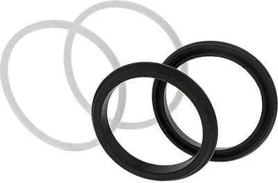 Two black and two white rings are arranged in a scattered formation on a white background.
