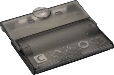 A close-up, angled view of a black and transparent plastic media tray for a Canon SELPHY printer.