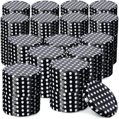 A collection of black metal lids with white polka dots, stacked in various arrangements.
