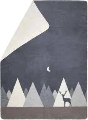 A blanket with a mountain and deer design.