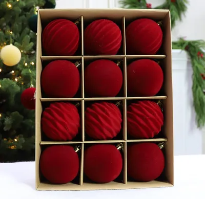 A box of red Christmas ornaments.