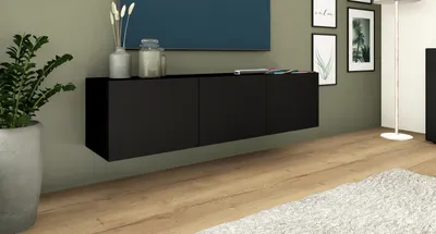 A modern living room scene featuring a black wall-mounted media console.