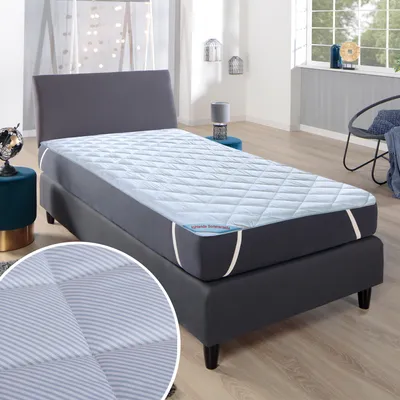 A mattress topper is shown on a bed in a bedroom setting.