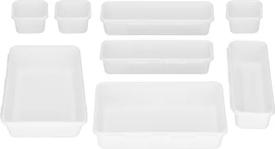 A collection of white plastic organizers of various sizes arranged on a white background.