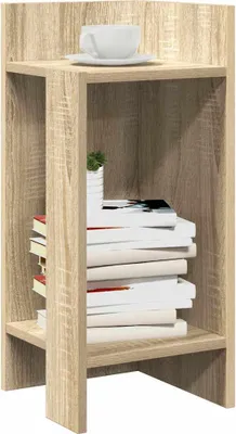 A wooden side table with books and a cup on it.