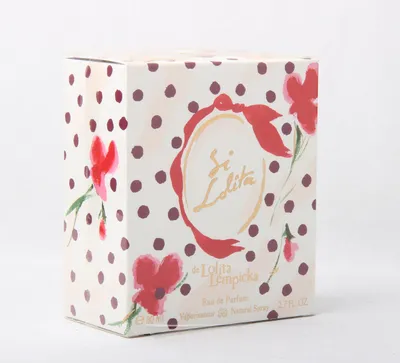 A product box for perfume, decorated with polka dots and floral illustrations.