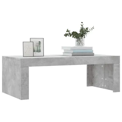 A concrete-effect coffee table with decorative items on top.